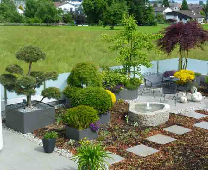 Der Garten - Eine Dachbegrünung fasst den Brunnen und die Eternitgefässe ein. Grosse Terrassen werden dadurch zum Garten